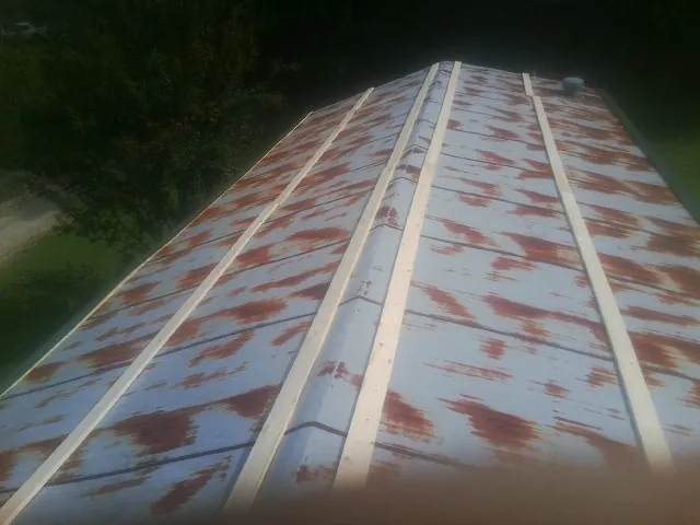 Rusted metal roof panels with new wood purlins before replacement — Storm Damage Roof Repair in Marlborough by Roofing Brothers