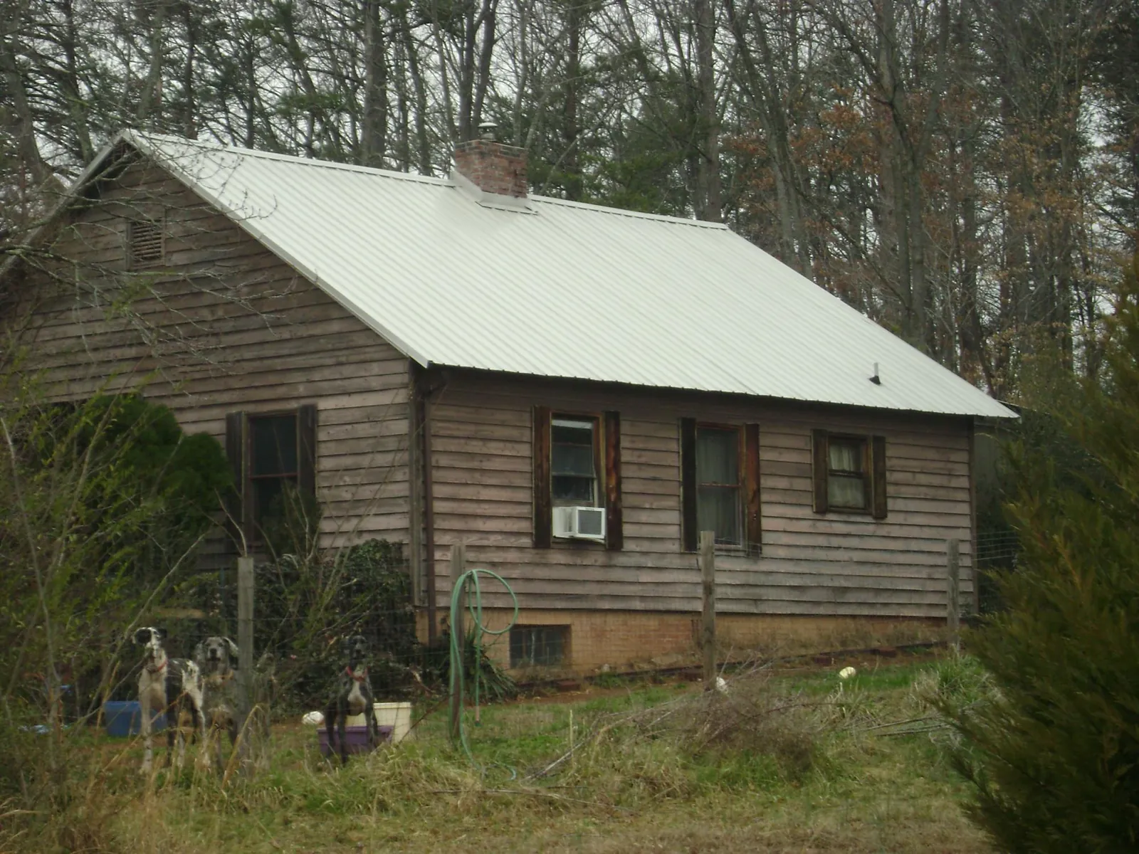 White metal roof on an old wood sided farmhouse, from a Metal Roof Installation job in Marlborough